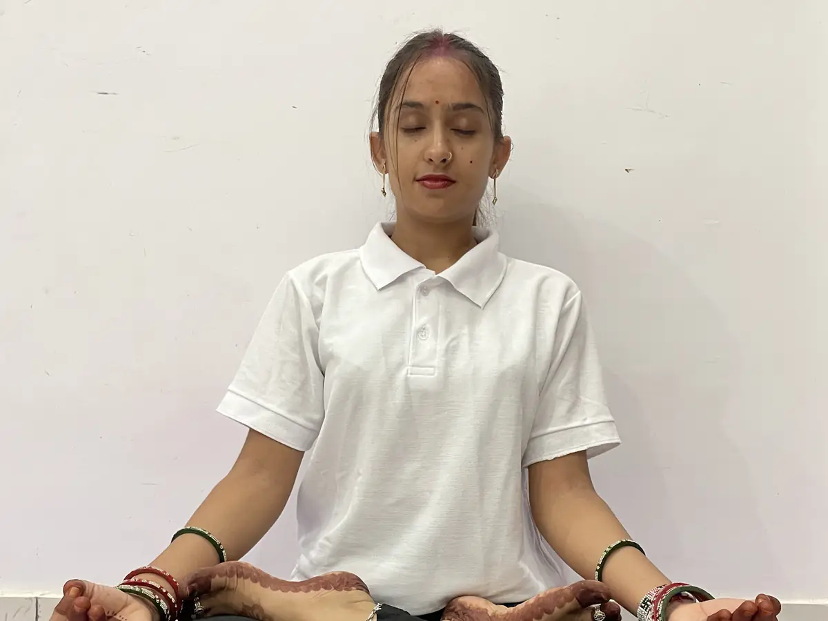 Latika seated in meditation with her eyes closed